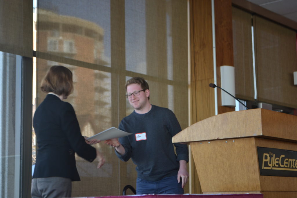 Benjamin Black, pictured receiving award from Department Chair Caroline Levine