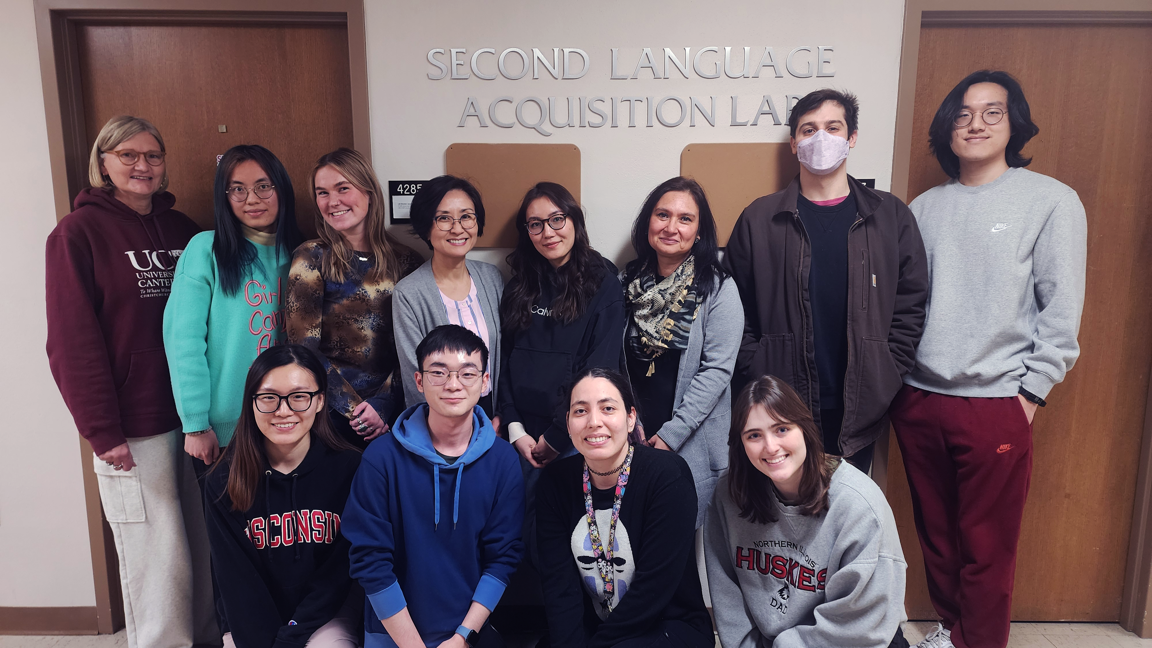 SLAB members in front of the lab, from left to right, featuring (Top row) Jill McLeod, Yongjia Deng, Sophie Boes, Professor Cho, Aruzhan Dauletkhan, Dr. Carolina Bernales, Joseph Moran, Ryan Shin; (Bottom row) Zimo Kong, Vatcharit Chantajinda, Fabiola Martinez, Sadie Collar.