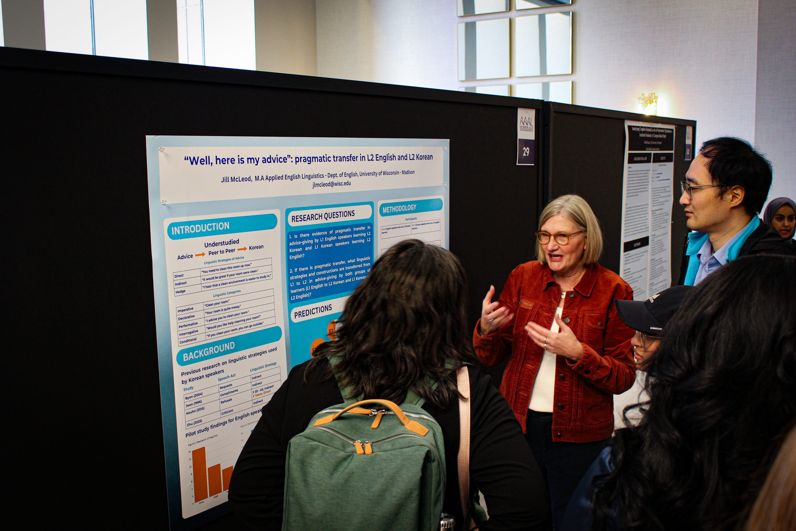 AEL graduate student Jill McLeod presenting her poster to other conferencegoers.